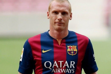 Barcelona's newly signed French soccer player Jeremy Mathieu poses while wearing his new jersey during his presentation at Camp Nou stadium, in Barcelona