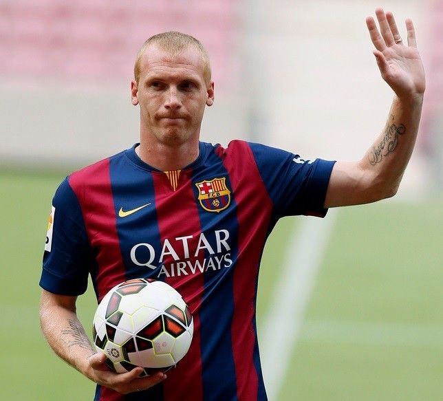 Barcelonas newly signed French soccer player Jeremy Mathieu waves while wearing his new jersey during his presentation at Camp Nou stadium, in Barcelona