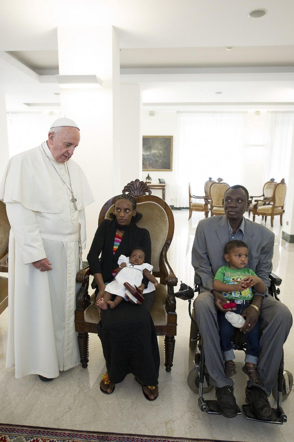 Pope Francis poses with Mariam Yahya Ibrahim of Sudan C, her husband and two children during a private meeting at the Vatican July 24, 2014. The Sudanese woman, who was spared a death sentence for converting from Islam to Christianity and then barred fr