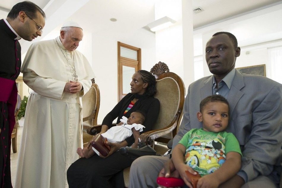 Pope Francis 2nd L talks with Mariam Yahya Ibrahim of Sudan, while her husband and two children sit beside her, during a private meeting at the Vatican July 24, 2014. The Sudanese woman, who was spared a death sentence for converting from Islam to Chris