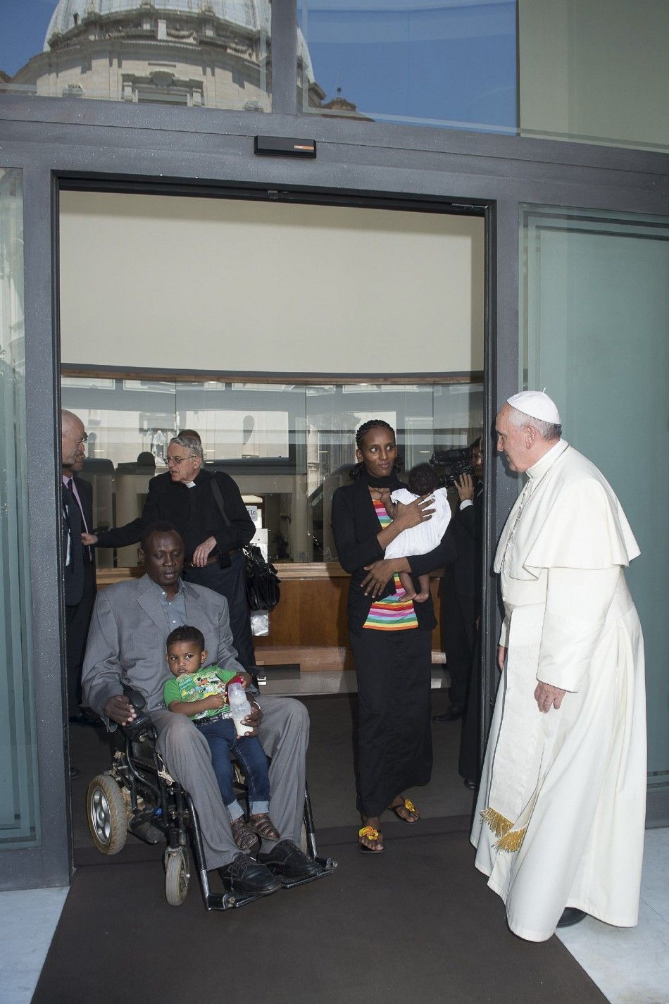 Pope Francis R greets Mariam Yahya Ibrahim 2nd R of Sudan, her husband and two children during a private meeting at the Vatican July 24, 2014. The Sudanese woman who was sentenced to death for converting from Islam to Christianity, then detained after
