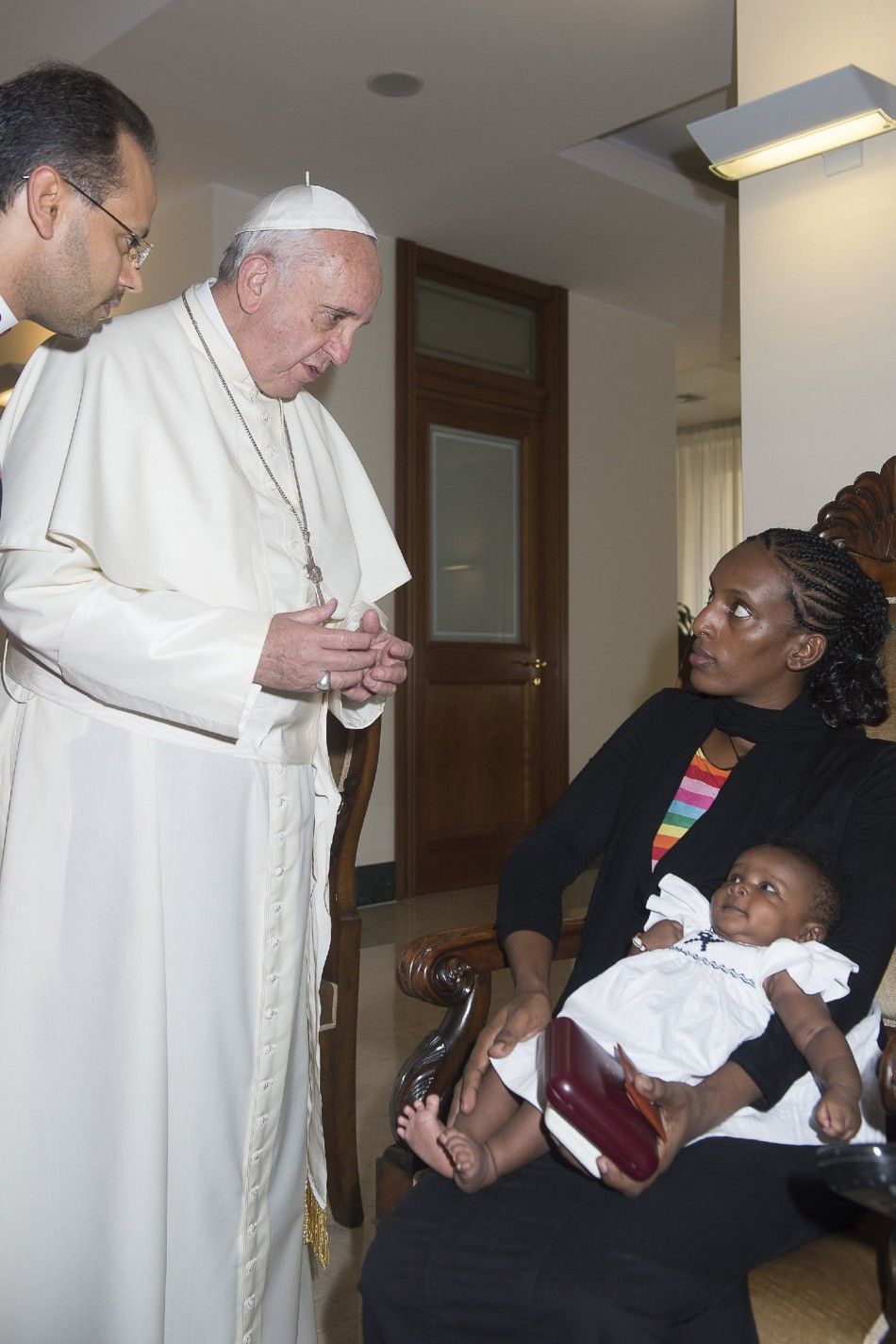 Pope Francis talks with Mariam Yahya Ibrahim of Sudan during a private meeting at the Vatican July 24, 2014. The Sudanese woman who was sentenced to death for converting from Islam to Christianity, then detained after her conviction was quashed, flew into
