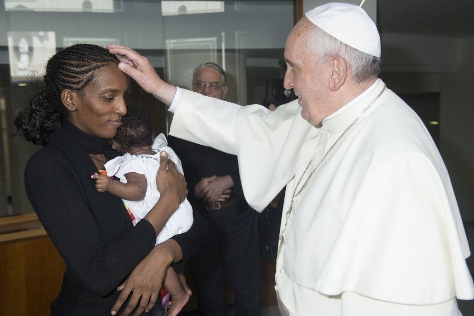 Pope Francis blesses Mariam Yahya Ibrahim of Sudan during a private meeting at the Vatican July 24, 2014. The Sudanese woman, who was spared a death sentence for converting from Islam to Christianity and then barred from leaving Sudan, flew into Rome on T