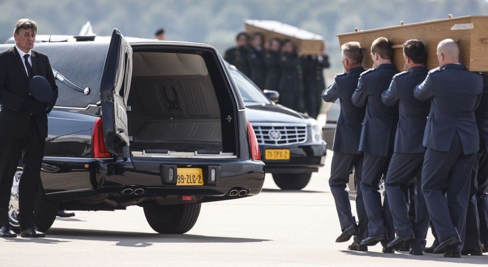 Coffins of the victims of Malaysia Airlines MH17, downed over rebel-held territory in eastern Ukraine, are loaded into a hearse on the tarmac, during a national reception ceremony, at Eindhoven airport July 24, 2014