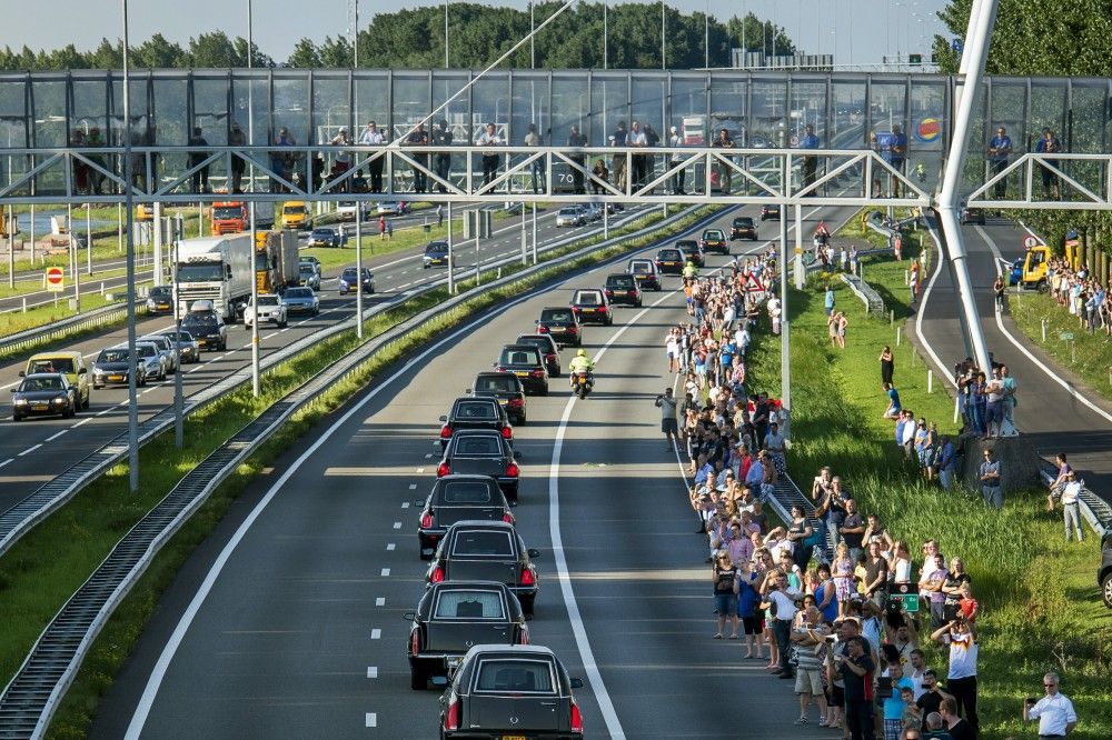 A convoy of hearses, bearing remains of the victims of the Malaysia Airlines Flight MH17 crash, are escorted along the A27 highway by military police to Hilversum, where they will be identified by forensic experts, near Nieuwegein July 23, 2014