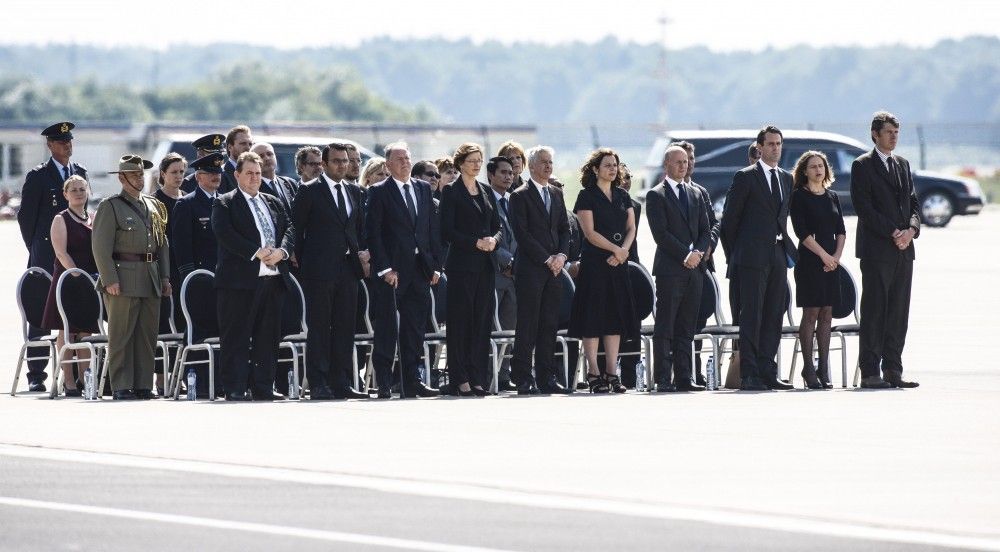 Dutch ministers Edith Schippers 5th R and Ronald Plasterk 6th R attend a national reception ceremony, for the coffins of the victims of Malaysia Airlines Flight MH17, at Eindhoven airport July 24, 2014.
