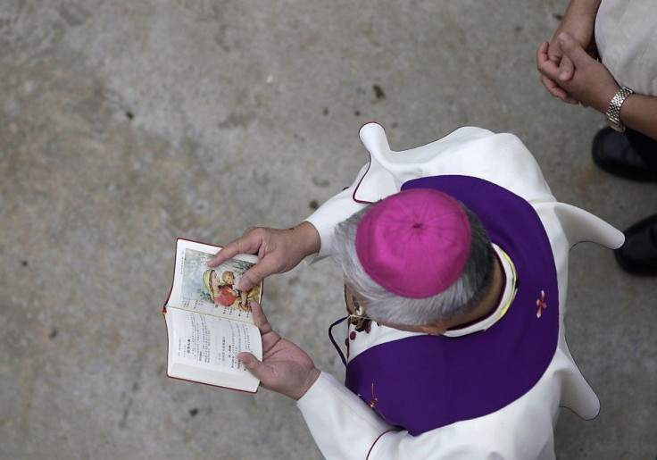 A Catholic bishop prays near the wreckage of a TransAsia Airways turboprop plane that crashed on Penghu island