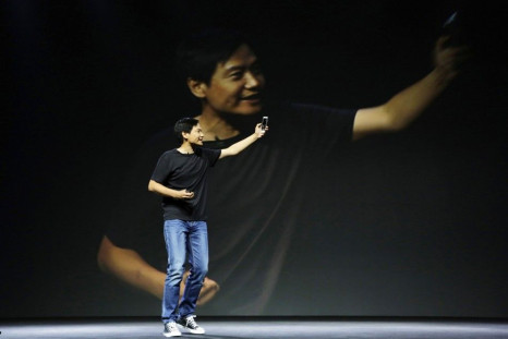 Lei Jun, founder and CEO of China's mobile company Xiaomi, shows new features at launch ceremony of Xiaomi Phone 4 in Beijing