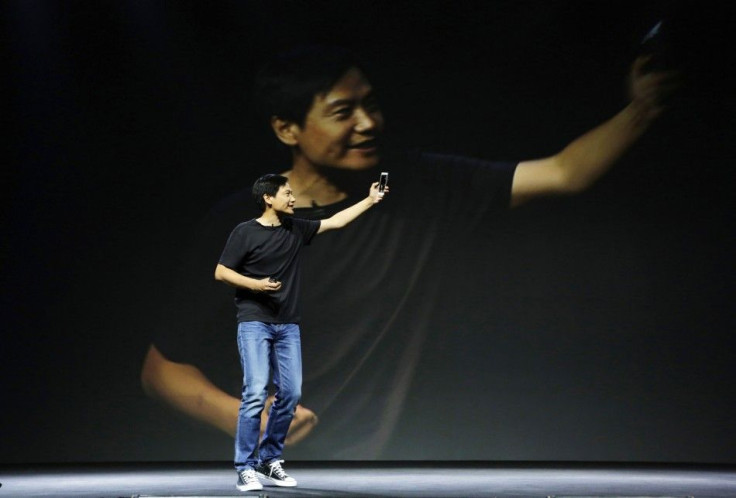 Lei Jun, founder and CEO of China's mobile company Xiaomi, shows new features at launch ceremony of Xiaomi Phone 4 in Beijing