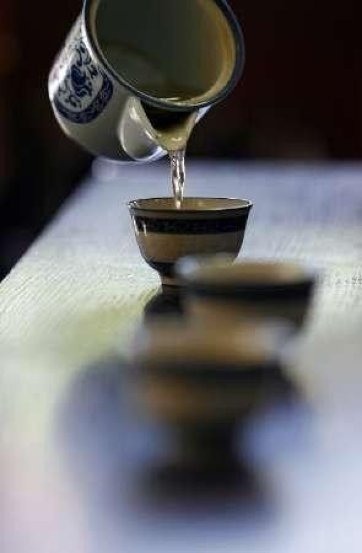 A woman pours tea into a tasting cup in Pinglin September 27, 2007.