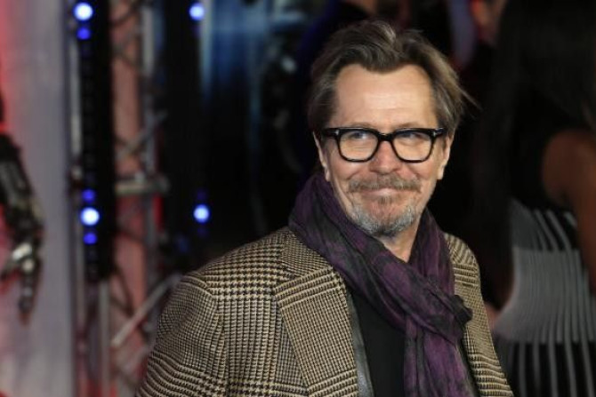 Cast member Gary Oldman poses for photographers as he arrives at the premiere of Robocop at the BFI IMAX Southbank in London in this February 5, 2014, file photo.