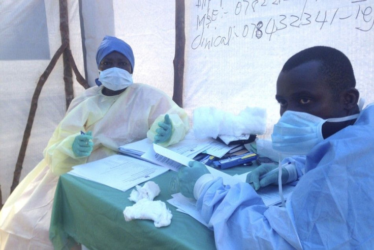 Government health workers are seen during the administration of blood tests for the Ebola virus in Kenema, Sierra Leone, June 25, 2014. 