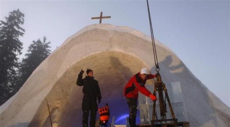 People work at the construction site of a Catholic church made of snow in the Bavarian village of Mitterfirmiansreut, near the German-Czech border, December 27, 2011.