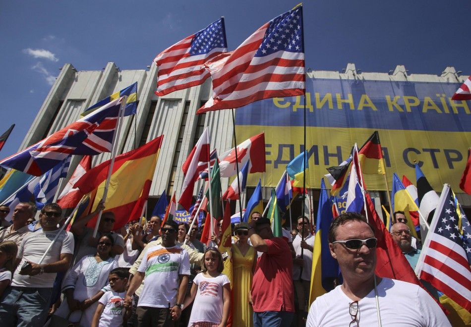 Foreign citizens working and living in Ukraine wave the flags of their countries during a rally demanding justice for the victims of the downed Malaysia Airlines Flight MH17, at Independence Square in Kiev July 27, 2014. Nearly 300 people, 193 of them Dut