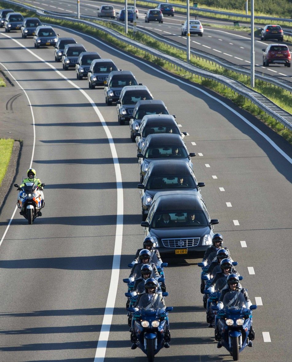 A row of hearses carrying victims of the Malaysia Airlines Flight MH17 plane disaster are escorted on highway A27 near Nieuwegein by military police, on their way to be identified by forensic experts in Hilversum, July 23, 2014. The bodies of the first vi