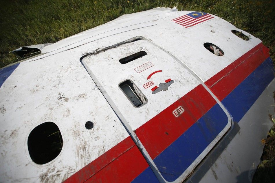 A piece of the wreckage is seen at a crash site of the Malaysia Airlines Flight MH17 near the village of Petropavlivka Petropavlovka, Donetsk region July 24, 2014. REUTERSMaxim Zmeyev UKRAINE - Tags TRANSPORT DISASTER