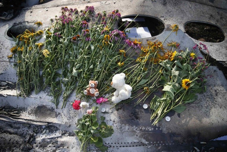 Flowers and mementos left by local residents lie on wreckage at the crash site of Malaysia Airlines Flight MH17, near the settlement of Grabovo in the Donetsk region in this July 19, 2014 file photo. 