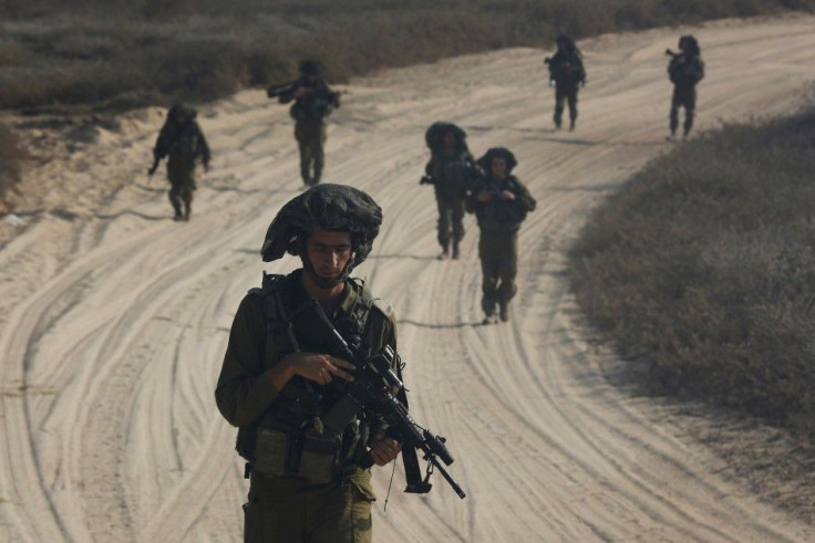 Israeli soldiers patrol outside the northern Gaza Strip