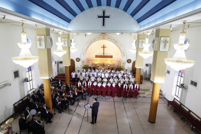 Singers and actors hired by state-run Iraqiya channel perform patriotic songs inside a church in Baghdad, July 21, 2014. State television is working overtime to persuade Iraqis to help Prime Minister Nuri al-Maliki confront an al Qaeda offshoot that has s