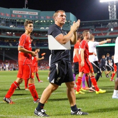 Liverpool manager Brendan Rodgers (C) and his team salute the fans following their international friendly soccer match against AS Roma at Fenway Park in Boston, Massachusetts July 23, 2014. Fenway Park is the home of the MLB baseball team the Boston Red S