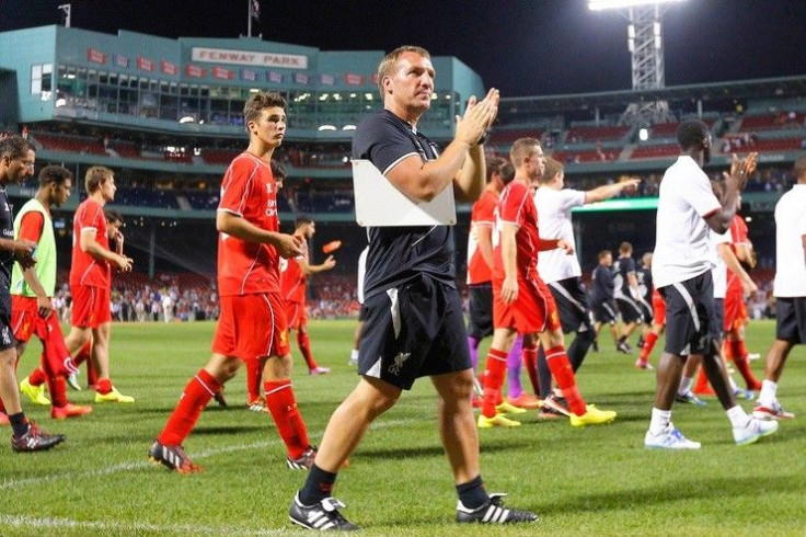 Liverpool manager Brendan Rodgers (C) and his team salute the fans following their international friendly soccer match against AS Roma at Fenway Park in Boston, Massachusetts July 23, 2014. Fenway Park is the home of the MLB baseball team the Boston Red S