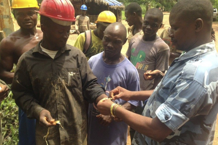 Government health workers administer blood tests to check for the Ebola virus 