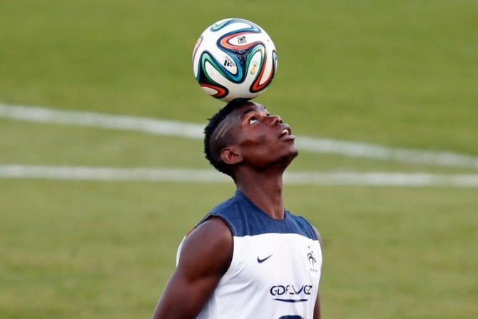 France&#039;s national soccer team player Paul Pogba controls the ball during a training session at the Botafogo soccer club&#039;s Santa Cruz stadium in Ribeirao Preto, 336 km (208 miles) northwest of Sao Paulo, in this June 17, 2014 file photo. Varane h
