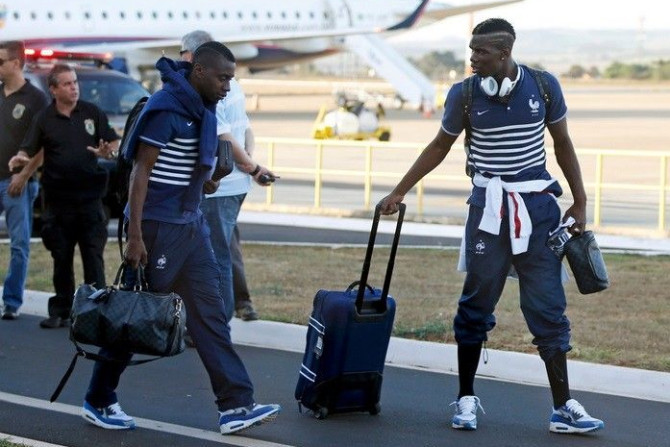 France's national soccer team players Blaise Matuidi (L) and Paul Pogba walk on the tarmac before boarding a flight at Ribeirao Preto as the team departs for Paris, July 5, 2014. France lost to Germany on July 4 in the 2014 World Cup quarter-finals a