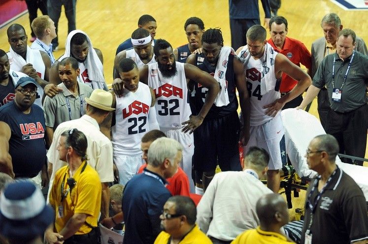 The USA Basketball team players and coaching staff look on as guard Paul George is tended to by medical personnel after suffering a leg injury during the USA Basketball Showcase at Thomas  Mack Center. 