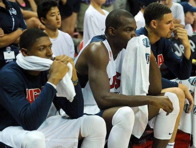 Players on the USA Team White bench react as Team Blue guard Paul George is tended to on the floor after suffering a leg injury during the USA Basketball Showcase at Thomas  Mack Center.