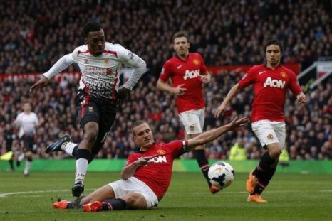 Manchester United's Nemanja Vidic (2nd L) fouls Liverpool's Daniel Sturridge (L) to concede a penalty and be sent off during their English Premier League soccer match at Old Trafford in Manchester, northern England, March 16, 2014.