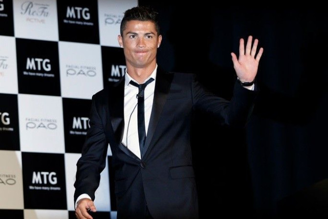 Real Madrid&#039;s Cristiano Ronaldo of Portugal waves upon arriving for a promotional event in Tokyo July 22, 2014. Ronaldo said on Tuesday he is focused on having another successful season after a disappointing campaign in the 2014 World Cup in Brazil.