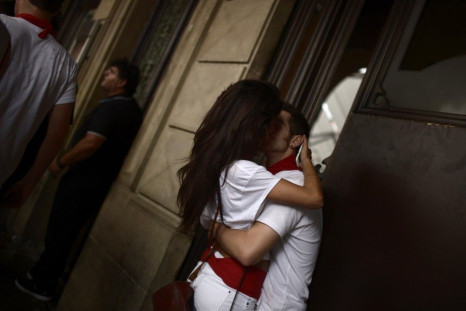 A couple kisses following the midday Chupinazo rocket announcing the start of the San Fermin festival in Pamplona