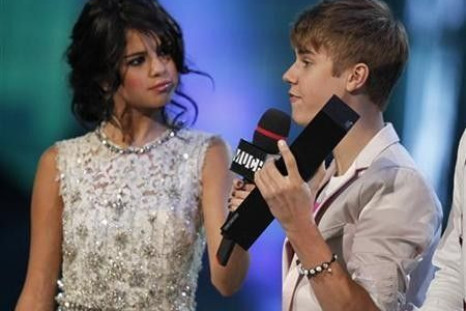 Justin Bieber Accepts The Award For 'Ur Fav Artist' For His Song 'Somebody To Love' From Host Selena Gomez During The MuchMusic Video Awards In Toronto