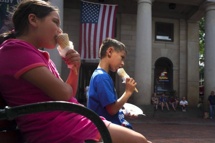 Two children eat ice cream cones at Quincy Marketplace on a summer's day in Boston