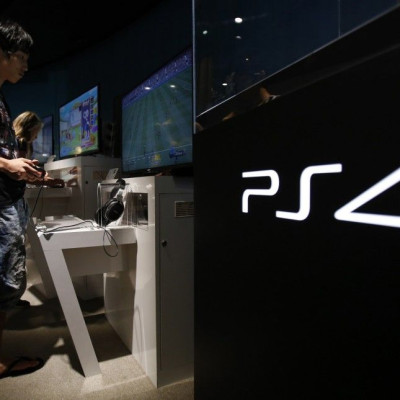 A Man Plays A Video Game on Sony Corp's Play Station 4 Console At Its Showroom In Tokyo