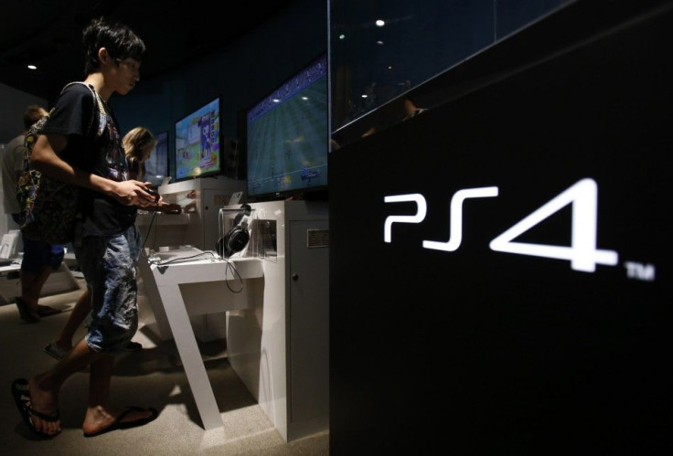 A Man Plays A Video Game on Sony Corp's Play Station 4 Console At Its Showroom In Tokyo