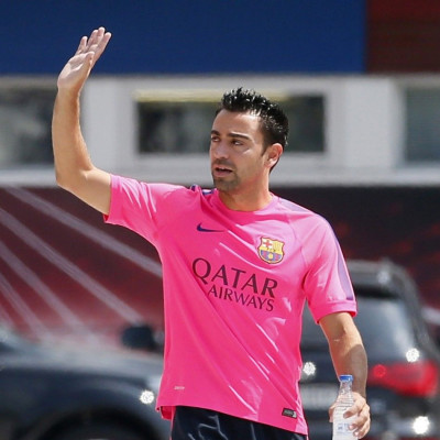 FC Barcelona&#039;s player Xavi Hernandez waves before a news conference at Joan Gamper training camp, near Barcelona August 5, 2014. Spain midfielder Xavi has retired from internationals at the age of 34, he said on Tuesday. The Barcelona player represen