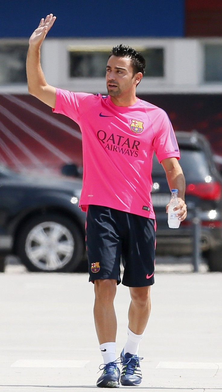 FC Barcelona&#039;s player Xavi Hernandez waves before a news conference at Joan Gamper training camp, near Barcelona August 5, 2014. Spain midfielder Xavi has retired from internationals at the age of 34, he said on Tuesday. The Barcelona player represen