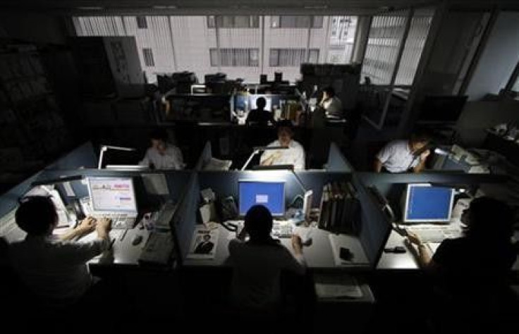 Employees work at a company office in Tokyo