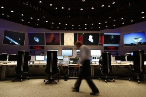 Scientists and mission control workers check their monitors at the European Space Agency&#039;s (ESA) main control room in Darmstadt, August 6, 2014.