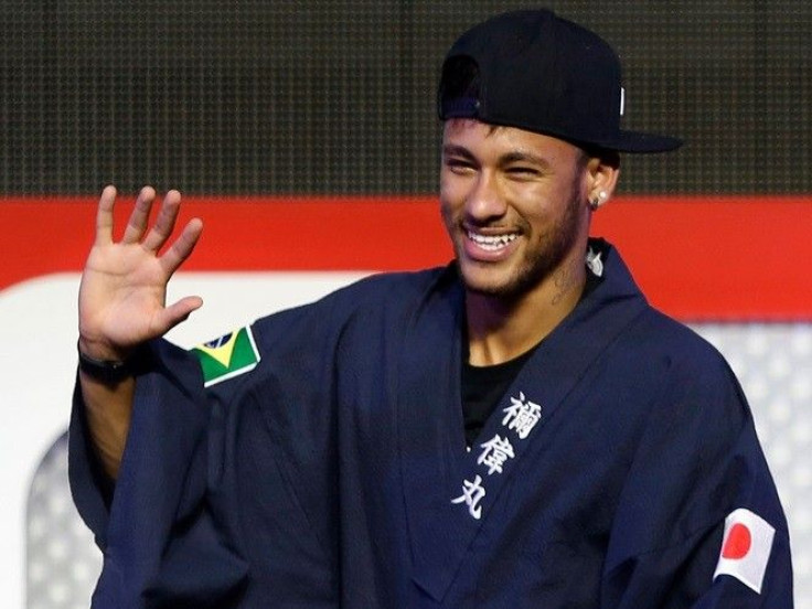 Brazilian soccer player and Barcelona forward Neymar waves as he wears a &quot;Yukata&quot;, a casual summer Kimono, after receiving it as a souvenir from the organizer during a fan event in Tokyo July 31, 2014. Neymar flew into Japan on Thursday for a pr