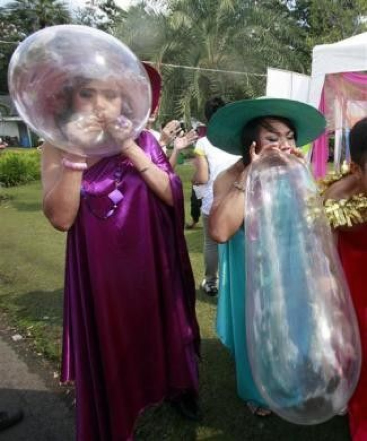 Members of Swing Service Workers in Group, a non-profit organisation for sex workers, blow condoms during a campaign to stop the spread of AIDS ahead of World AIDS Day, in Bangkok November 29, 2009. World AIDS Day takes place on December 1, 2009.