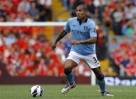 Manchester Citys Nigel de Jong runs with the ball during their English Premier League soccer match against Liverpool at Anfield in Liverpool, northern England, August 26, 2012