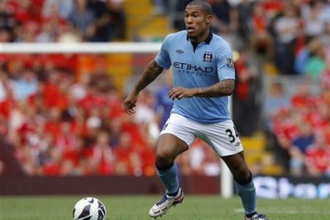 Manchester City's Nigel de Jong runs with the ball during their English Premier League soccer match against Liverpool at Anfield in Liverpool, northern England, August 26, 2012