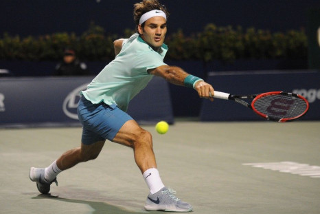 Roger Federer (SUI) returns a shot against Feliciano Lopez (ESP)