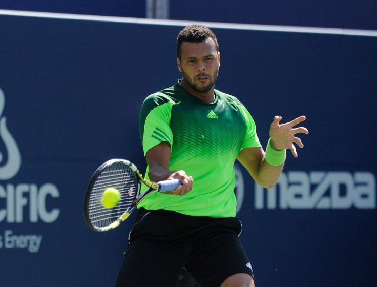 Jo Wilfried Tsonga (FRA) plays a forehand against Roger Federer