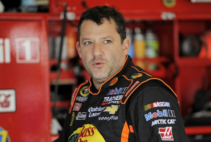 NASCAR Sprint Cup Series driver Tony Stewart speaks with crew members during practice for the Daytona 500 qualifying at Daytona International Speedway in Daytona Beach, Florida, in this file photo taken February 16, 2013. Stewart canceled plans to compete
