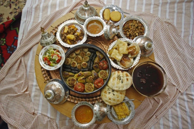 Dolma, a traditional dish of stuffed vegetables, and other food are laid out on a table at Mrgic's home in Zenica