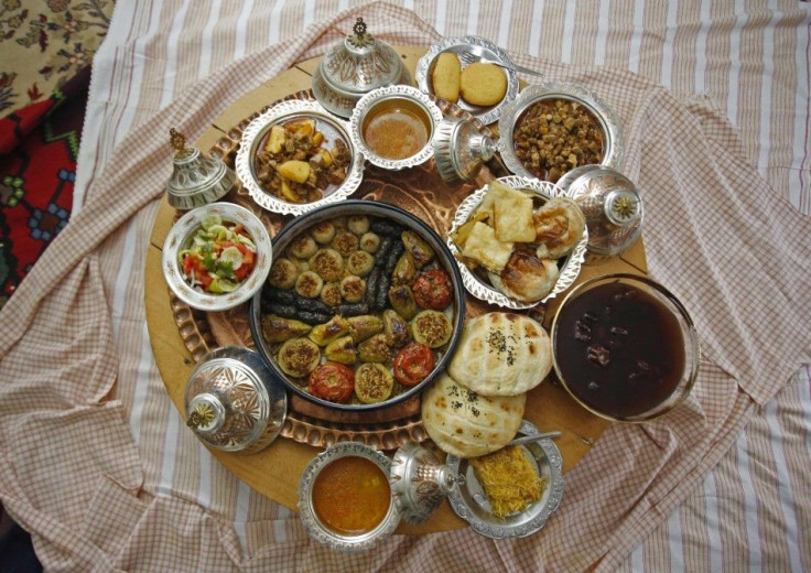 Dolma, a traditional dish of stuffed vegetables, and other food are laid out on a table at Mrgic's home in Zenica